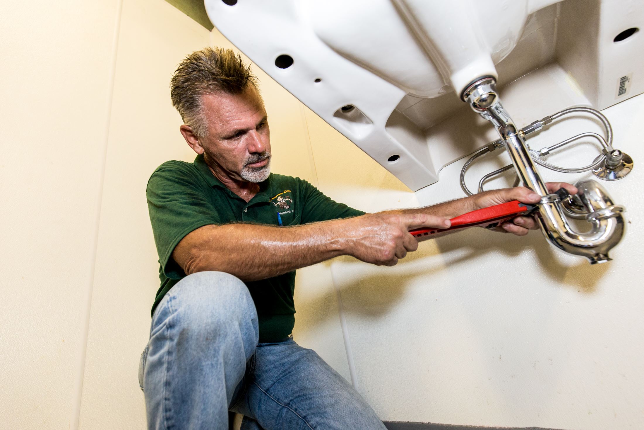 plumber working on a sink